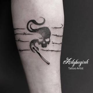 Skull on fire on spiked fence tattoo by Artybugink